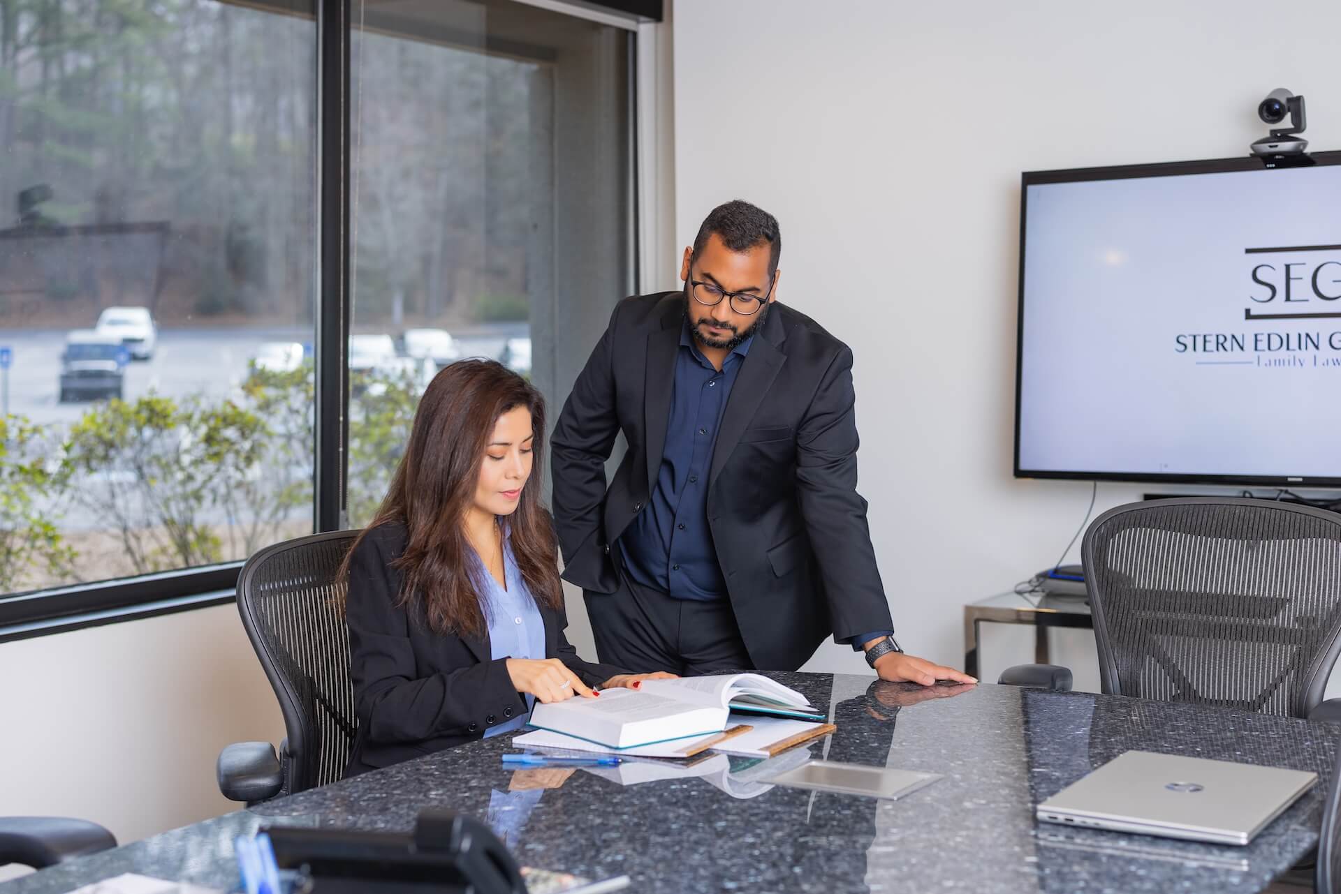 Two Stern Edlin Graham attorneys reviewing a case file in the conference room