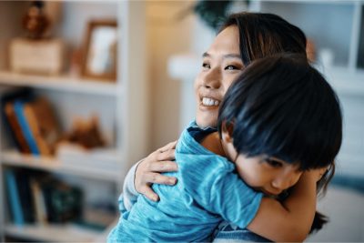 Mother holding her toddler at home