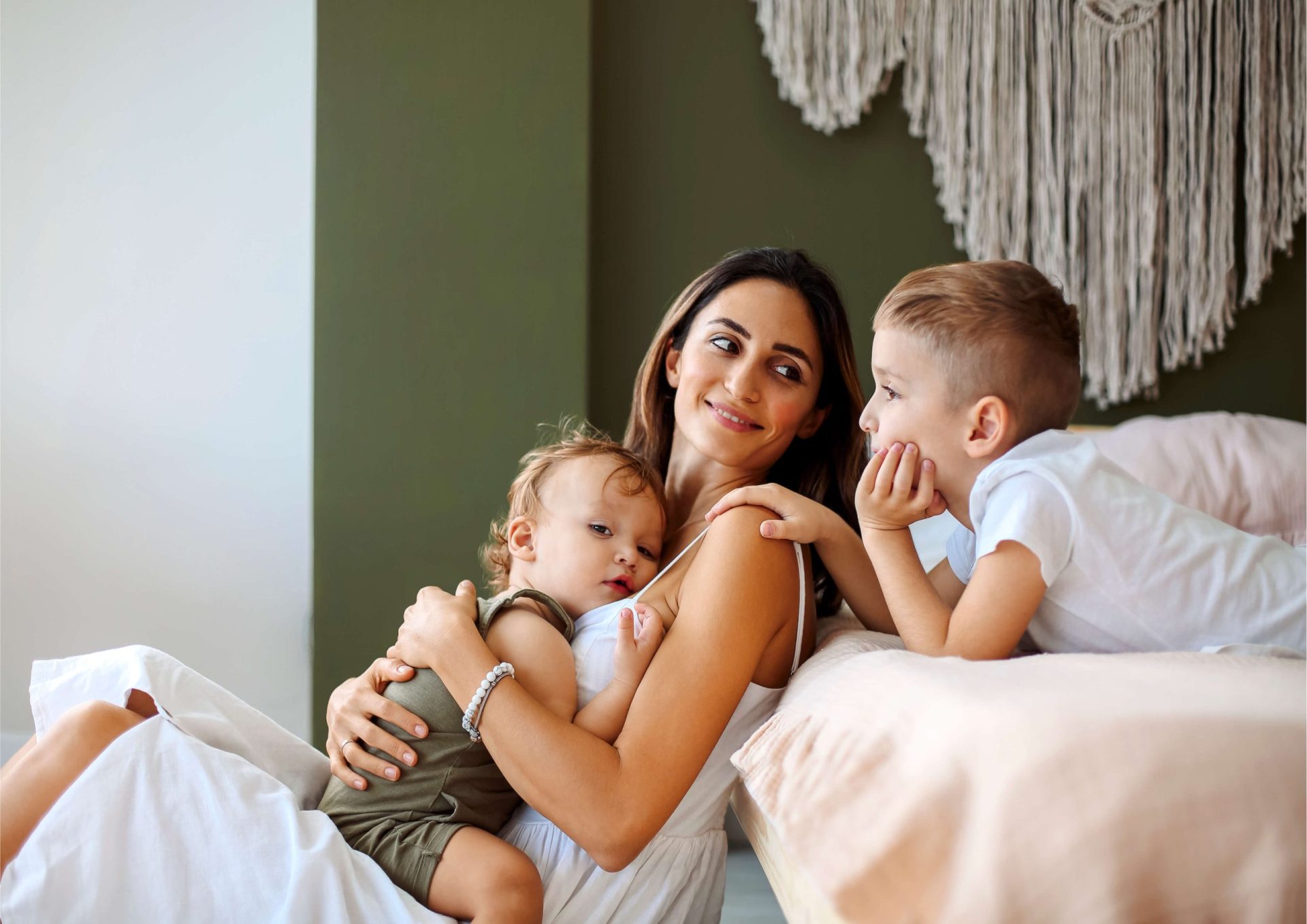 Mother relaxing with her two children at home